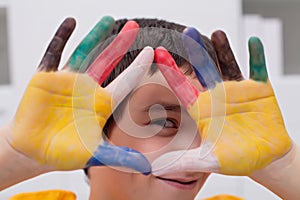 Boy with colored hands