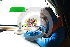 Boy in compartment of retro train carriage