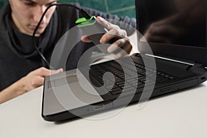 Boy connecting external hard drive