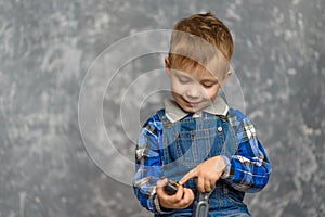 The boy in the construction glasses scratches his head photo