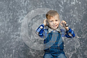 The boy in the construction glasses scratches his head photo