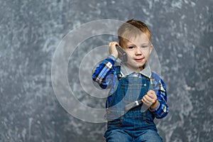 The boy in the construction glasses scratches his head photo