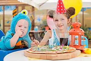 Boy in costumes of monsters and girl in festive