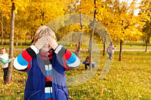 Boy counting while friends hiding