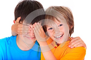 Boy covering brothers eyes