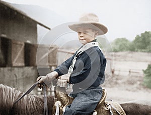 Boy in a cowboy hat on a horse