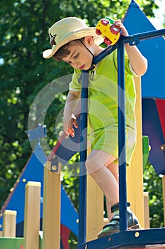 Boy in cowboy hat on the playground