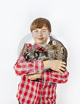 Boy cradles his tabby cat