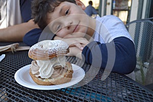 Boy with cream filled bun