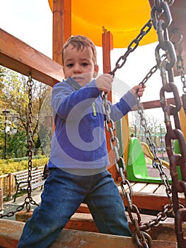 Boy crossing bridge at the playground