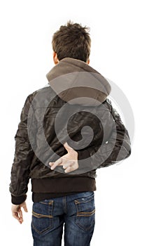 Boy crossing fingers behind back