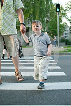 Boy crossing the street at a crosswalk