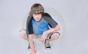 Boy crouching photo