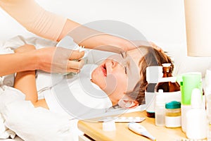 Boy crying while mother helping to blow his nose