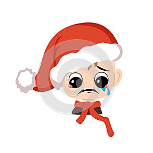 Boy with crying and tears emotion, sad face, depressive eyes in red Santa hat