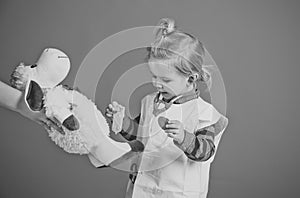 Boy cure toy sheep with vaccine on blue background