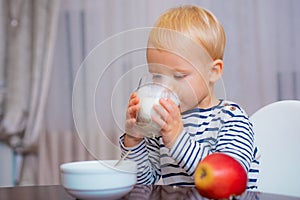 Boy cute baby eating breakfast. Baby nutrition. Eat healthy. Toddler having snack. Healthy nutrition. Drink milk. Child