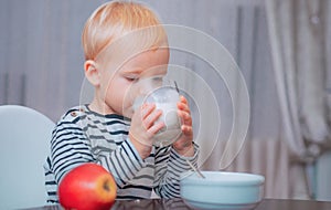 Boy cute baby eating breakfast. Baby nutrition. Eat healthy. Toddler having snack. Healthy nutrition. Drink milk. Child