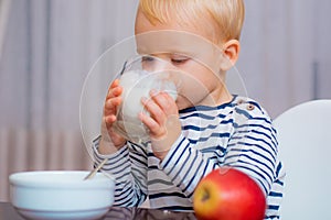 Boy cute baby eating breakfast. Baby nutrition. Eat healthy. Toddler having snack. Healthy nutrition. Drink milk. Child