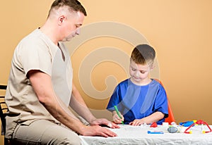 Boy cute child and his father doctor. Hospital worker. First aid. Medical help. Trauma and injurie. Medicine concept photo