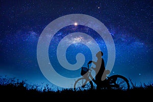 The boy is cycling in the midst of the stars galaxy photo