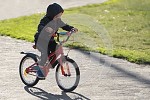 Boy Cycling in the open air. Child learns to ride a bike