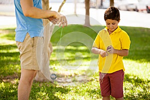 Boy and dad playing with a yo-yo