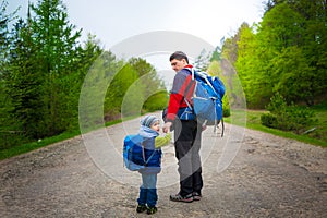 The boy and the dad are on the road.