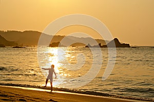 Boy dancing in the rising sun