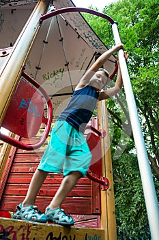 Boy descending on pole