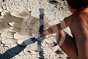 Boy in the desert. Exhausting heat.