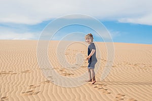 Boy in the desert. Traveling with children concept