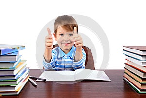 Boy at the desk shows thumbs up
