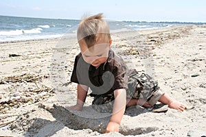 Boy digging in the sand