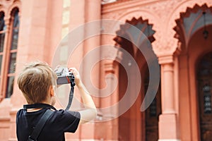 Boy with a digital camera taking pictures. School project for kids. Future profession