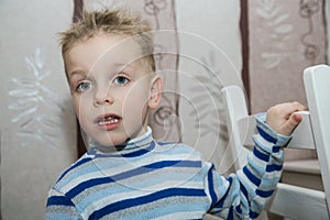 Boy with disheveled hair standing