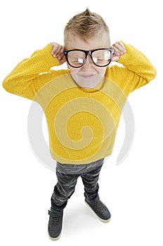 The Boy dissatisfied with the fact that prescribed glasses - does not want to wear. Eye health care. High angle