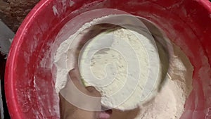 A boy is disturbing the flour with hand