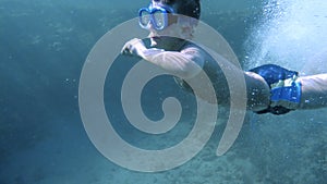 Boy dive in the Red sea with underwater mask