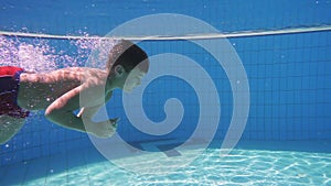 Boy dive in swimming pool