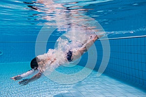 Boy dive in swimming pool