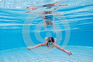 Boy dive in swimming pool