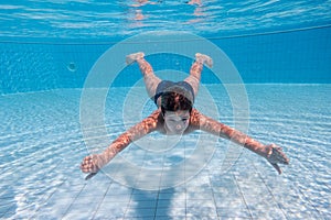 Boy dive in swimming pool