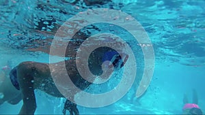 Boy dive in swimming pool, underwater shoot