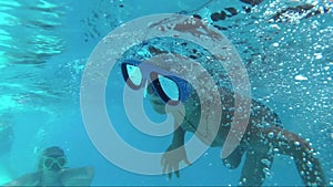 Boy dive in swimming pool, underwater shoot