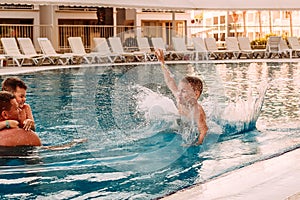 The boy dived into the outdoor pool. Family holidays in the hotel