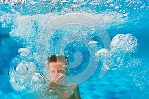 Boy diving in swimming pool