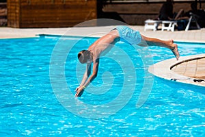 Boy diving in swimming pool