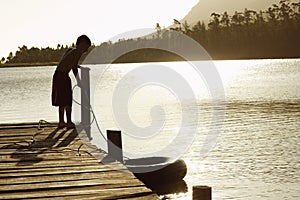 Boy On Dock Pulling In Float Tube