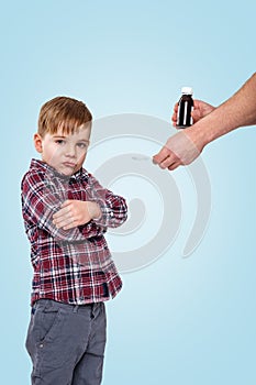 Boy doesn`t want to take medicine from his mother